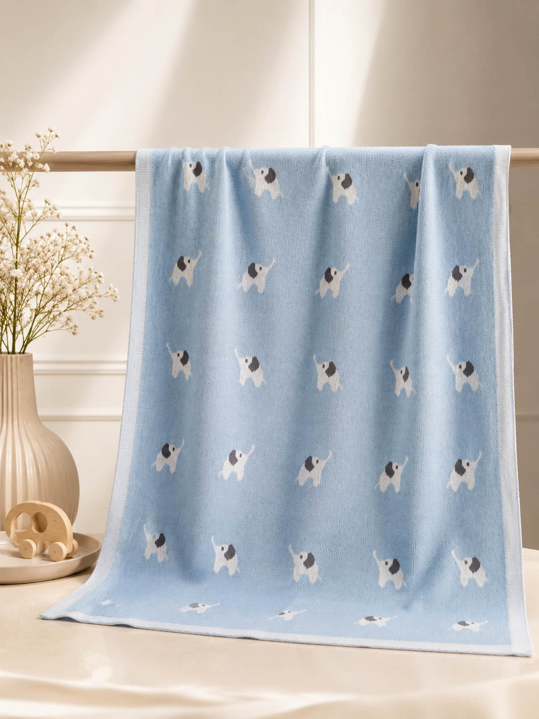 Blue blanket with dog pattern on a light wooden surface